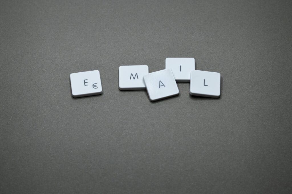 Scattered keyboard keys spelling "EMAIL" on a white surface, symbolizing digital communication and workplace email policies.